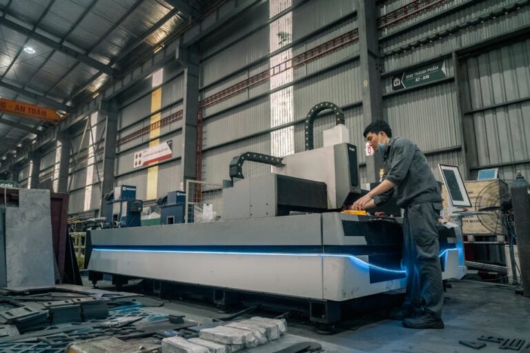 A worker with a mask operating machinery in a spacious industrial warehouse.